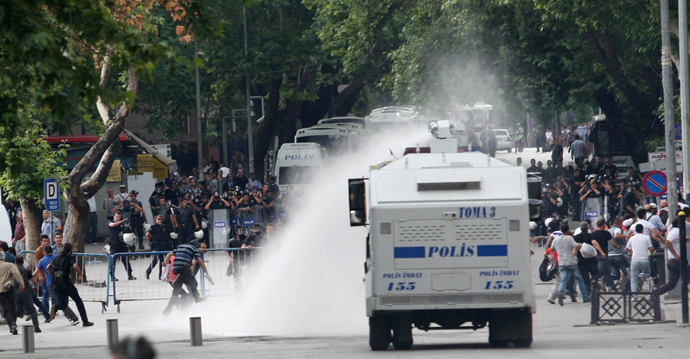 Protesters escape from a water cannon as they clash with police during an anti-government demonstration in Ankara on June 16, 2013 (AFP Photo / Adem Altan)