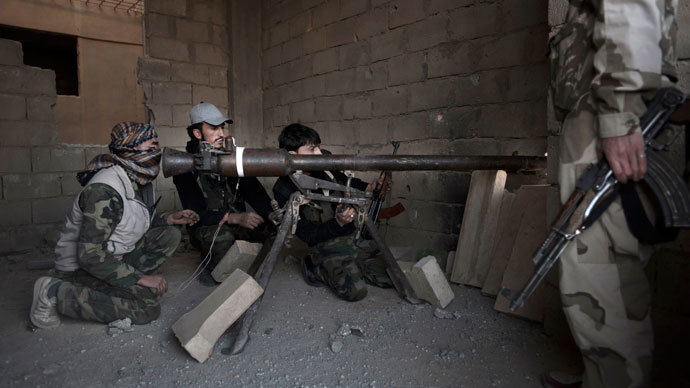 Rebels fighters prepare to fire a portable canon against an adjacent Syrian government-held building during fighting.(AFP Photo / Zac Baillie)