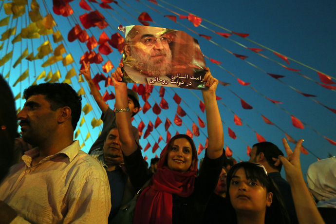 Iranians celebrate the victory of moderate presidential candidate Hassan Rowhani (portrait) in the Islamic Republic's presidential elections at Vanak square in northern Tehran on June 15, 2013 (AFP Photo / Atta Kenare)