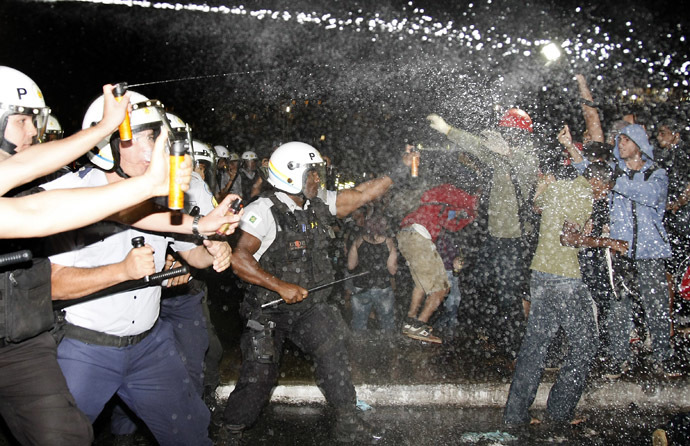 Police spray demonstrators with pepper gas during a student protest at National Congress in Brasilia, on June 20, 2013 within what is now called the 'Tropical Spring' against corruption and price hikes. (AFP Photo)