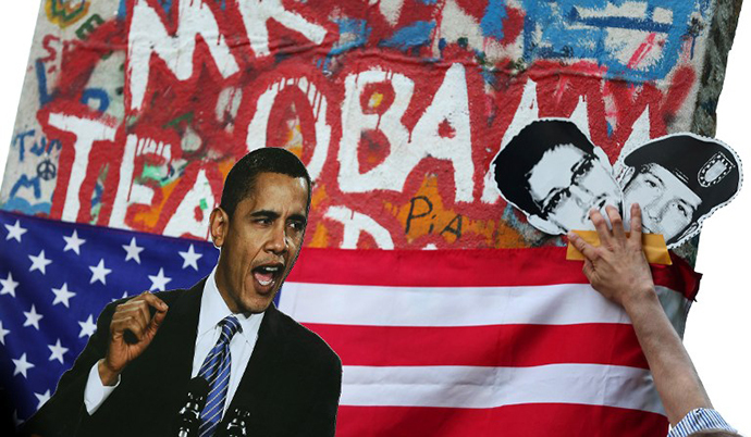Activists display a photo of US President Barack Obama and pictures of former US spy Edward Snowden and whistleblower Bradley Manning during a protest action (AFP photo / Ronny Hartmann)