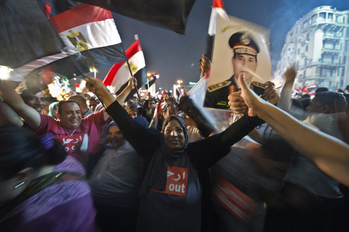 People celebrate at Tahrir Square with a portrait of Army chief Abdel Fattah al-Sisi after a broadcast confirming that the army will temporarily be taking over from the country's first democratically elected president Mohammed Morsi on July 3, 2013 in Cairo. (AFP Photo)