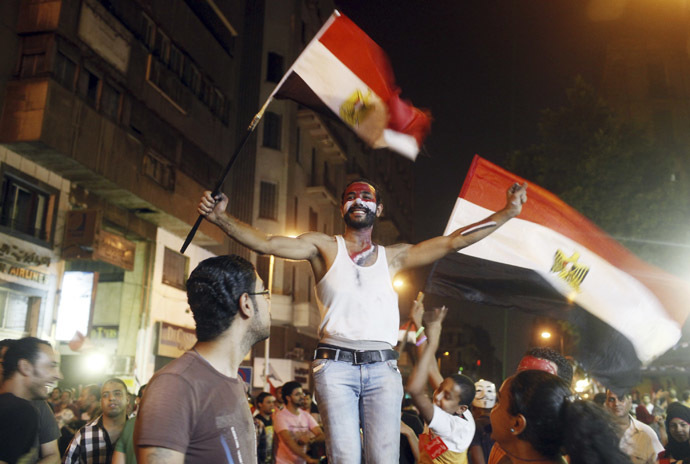An anti-Mursi protester dances as people celebrate near Tahrir square after the announcement of the removal from office of Egypt's deposed President Mohamed Mursi in Cairo, July 3, 2013. (Reuters)