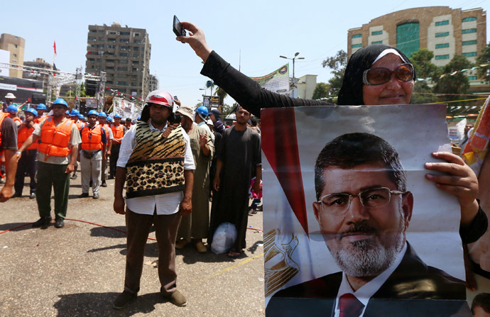 Egyptian supporters of Muslim Brotherhood and Egypt's ousted president Mohamed Morsi (on the poster) take part in a self-defense training outside Rabaa al-Adawiya mosque on July 16, 2013 in Cairo. (AFP Photo)