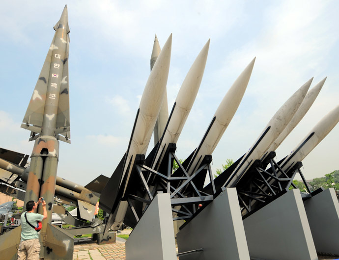 A visitor takes pictures of replicas of North Korea's Scud-B missile, (center green) and South Korean missiles that are displayed at the Korean War Memorial in Seoul on June 28, 2010. (AFP Photo)
