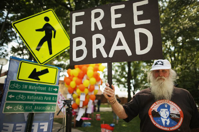Supporters of U.S. Army Private First Class Bradley Manning protest his detention by marching around the perimeter and blocking the gates of Fort McNair on the final day of closing arguments in his military trial July 26, 2013 in Washington, DC. (AFP Photo / Chip Somodevilla)