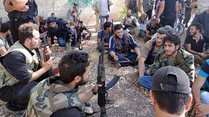 A handout image released by the Syrian opposition's Shaam News Network on July 30, 2013, shows rebel fighters gathered in the grounds of a school to receive instructions on July 27, 2013, the southern city Daraa. (AFP Photo)