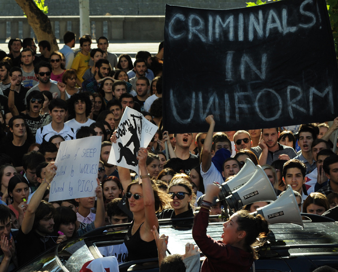 Georgian students hold a placard as they shout during a protest against torture in prisons in Tbilisi on September 24, 2012 (AFP Photo / Vano Shlamov)