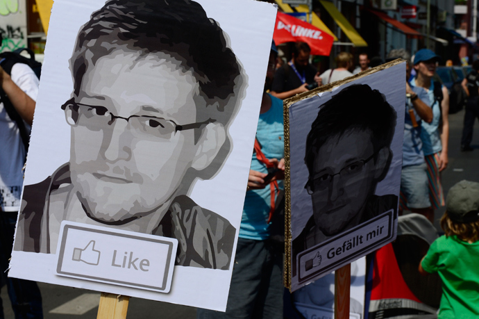 Demonstrators hold placards featuring an image of former US intelligence contractor Edward Snowden as they take part in a protest against the US National Security Agency (AFP Photo / John Macdougall) 