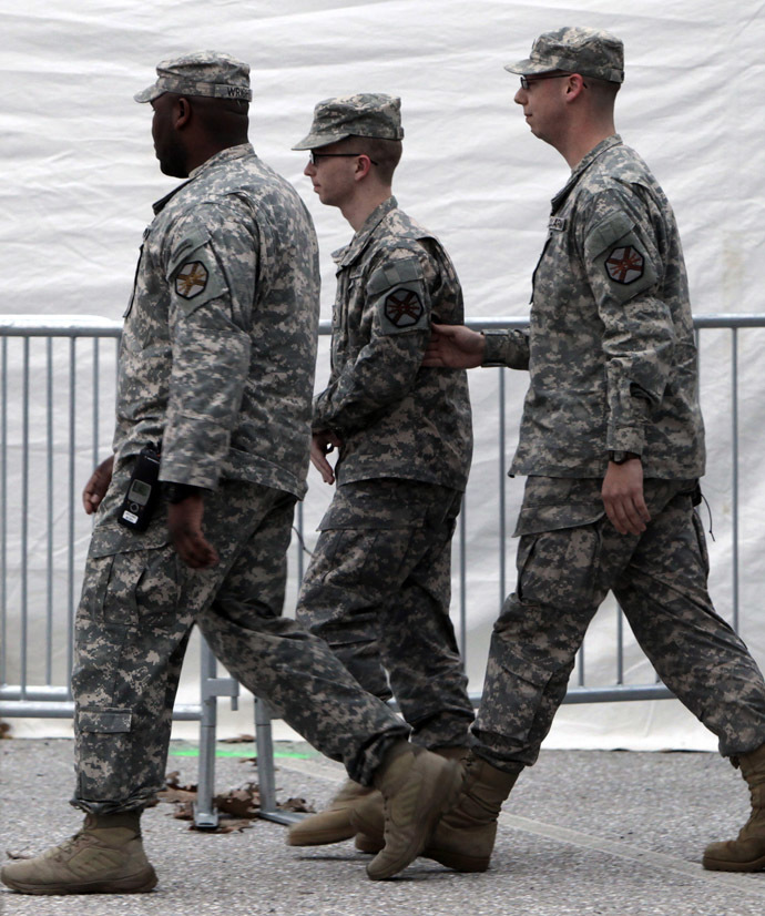 Bradley Manning (C) is escorted from the courthouse at Fort Meade, Maryland after his Article 32 hearing December 16, 2011. (Reuters/Yuri Gripas)