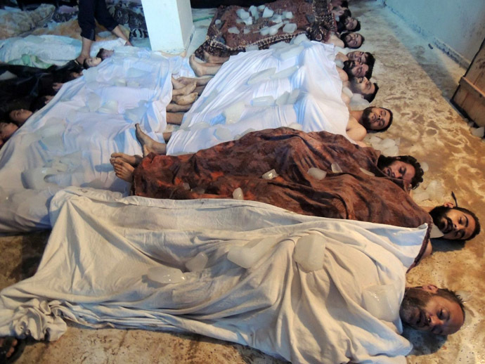  A handout image released by the Syrian opposition's Shaam News Network shows bodies laid out on the ground in a makeshift morgue as Syrian rebels claim they were killed in a toxic gas attack by pro-government forces in eastern Ghouta, on the outskirts of Damascus on August 21, 2013. (AFP Photo/Shaam News Network)