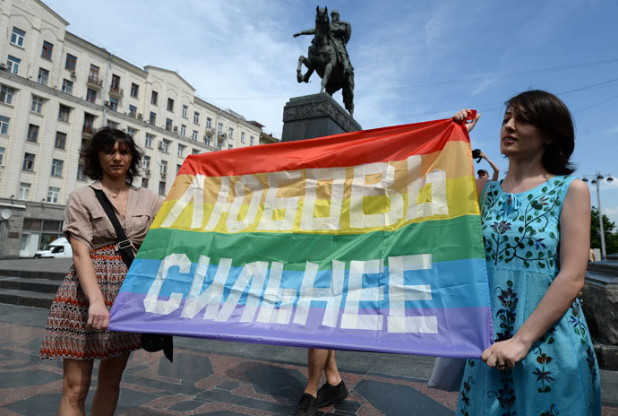 Participants in an unauthorized rally held by gay activists next to the Yury Dolgoruky monument on Tverskaya Square in Moscow. The sign reads "Love is Stronger" (RIA Novosti / Alexey Filippov)