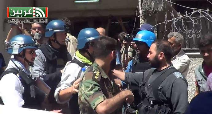 A image grab taken from a video distributed by Arbeen Unified Press office on August 28, 2013 shows United Nations (UN) arms experts arriving to inspect the site where rockets had fallen in Damascus' eastern Ghouta suburb as they investigate an alleged chemical weapons strike near the capital. (AFP)