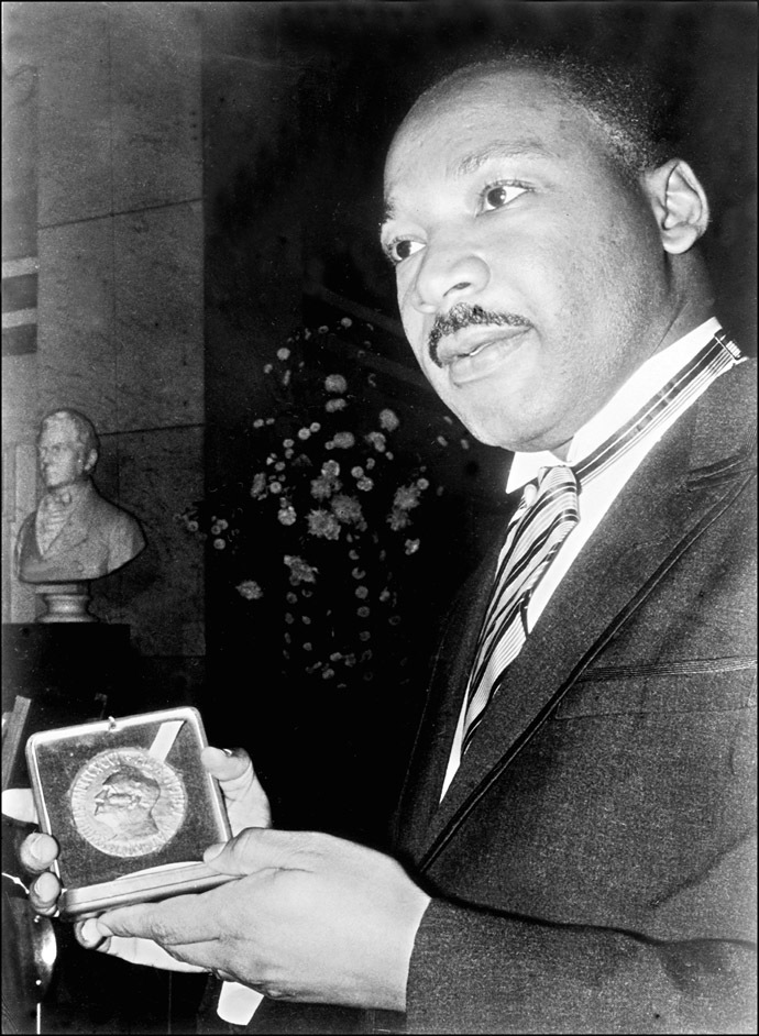 US clergyman and leader of the Movement against Racial Segregation Martin Luther King, displays 10 December 1964 in Oslo his Nobel Peace Prize medal. (AFP Photo)
