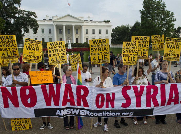 Demonstrators march in protest during a rally against a possible US and allies attack on Syria in response to possible use of chemical weapons by the Assad government, in Lafayette Park in front of the White House in Washington, DC on August 29, 2013. (AFP Photo / Saul Loeb)