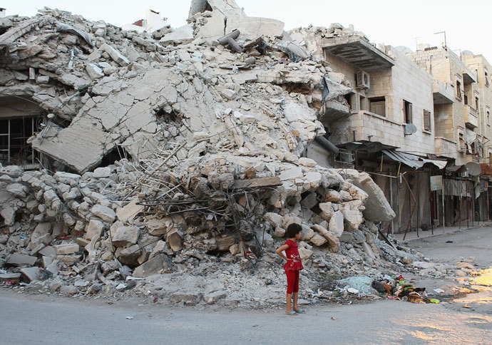 A girl stands in front of a building damaged by what activists said was shelling by forces loyal to Syria's President Bashar al-Assad in the northern town of Ariha in Idlib Province September 8, 2013.(Reuters / Houssam Abo Dabak)