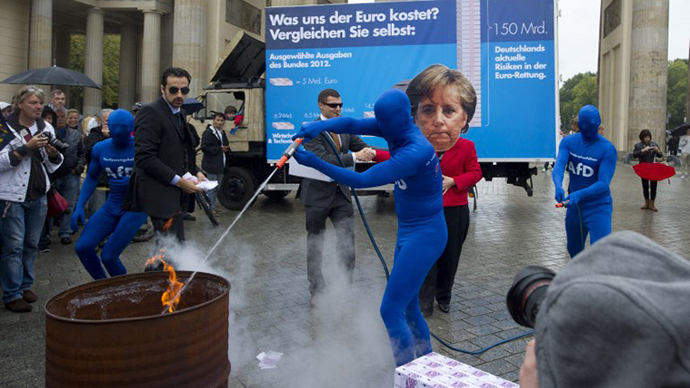 Germany's fledgling anti-euro party Alternative for Germany (Alternative fuer Deutschland, AfD) members play a scene with a person wearing a mask featuring German Chancellor Angela Merkel (C) and AfD members extinguishing a fire set on fake Euro Banknotes during an electoral action in front of the Brandenburg Gate on September 16, 2013 in Berlin, ahead of the General election. (AFP Photo / Barbara Sax)