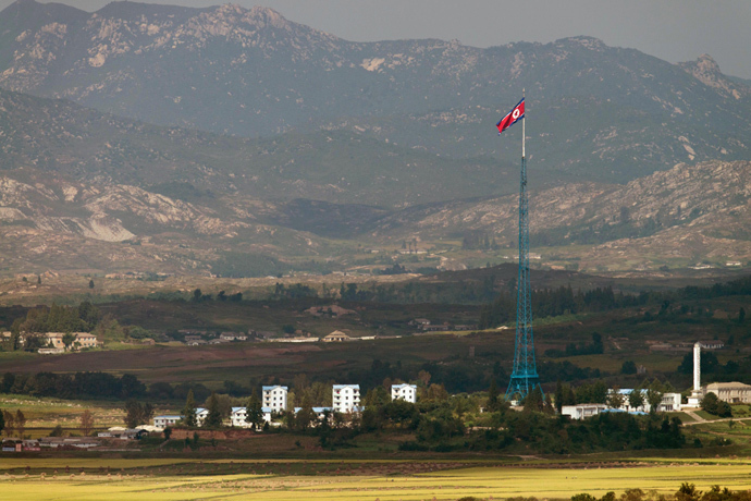 A North Korean flag flutters over North Korea's village of Gijungdong as seen from an observatory point in Paju near the Demilitarized Zone (DMZ) dividing the two Koreas (AFP Photo / Kim Doo-Ho) 
