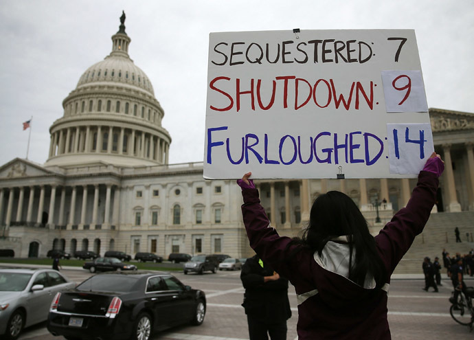 A women holds a sign that reads (Sequestered 7, Shutdown 9, Furloughed 14) during a rally in front of the U.S. Capitol, October 9, 2013 in Washington, DC. (Mark Wilson/Getty Images/AFP)