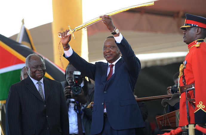 Kenya's fourth president Uhuru Kenyatta receives a sword as a symbol of authority from former president Mwai Kibaki (L) during his inauguration at the Moi International Sports Center Kasarani in Nairobi on April 9, 2013. (AFP Photo/Simon Maina)