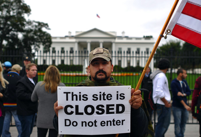 A protester holds a sign during a demonstration in front of the White House in Washington, DC, on October 13, 2013 demanding an end to the US federal government shutdown (AFP Photo/Jewel Samad)