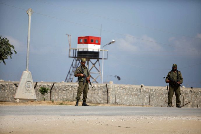 Palestinian members of security forces loyal to Hamas stand guard on the border between Egypt and southern Gaza Strip July 5, 2013. (Reuters/Ibraheem Abu Mustafa)
