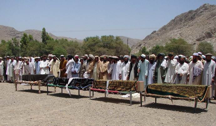 Pakistani tribesmen gather for funeral prayers before the coffins of people allegedly killed in a US drone attack, claiming that innocent civilians were killed during a June 15 strike in the North Waziristan village of Tapi, 10 kilometers away from Miranshah, on June 16, 2011. (AFP Photo)