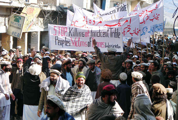 Pakistani tribesmen hold banners as they march during a protest rally against the US drone attacks, in Miranshah, the main town in North Waziristan district on January 21, 2011. (AFP Photo)