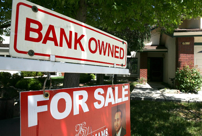 A bank owned for sale sign is posted in front of a foreclosed home in Antioch, California. (AFP Photo / Justin Sullivan)