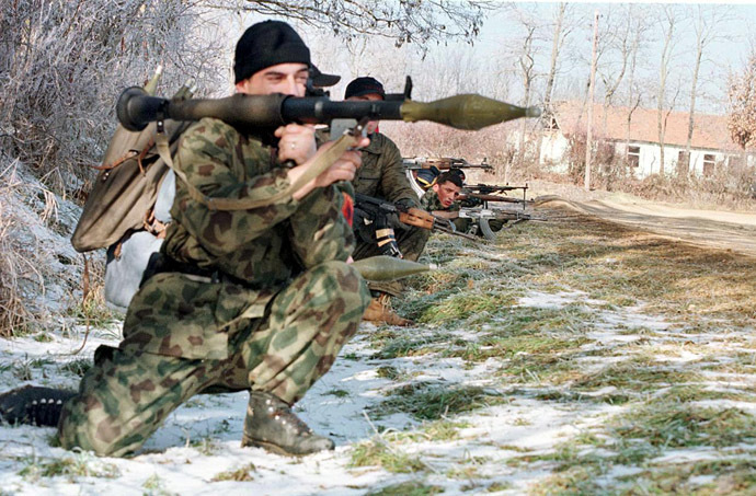 Members of the Kosovo Liberation Army (KLA) man a position on the road near the northern Kosovo village of Llapashtica in the region of Podujevo 26 January 1998 (AFP Photo)