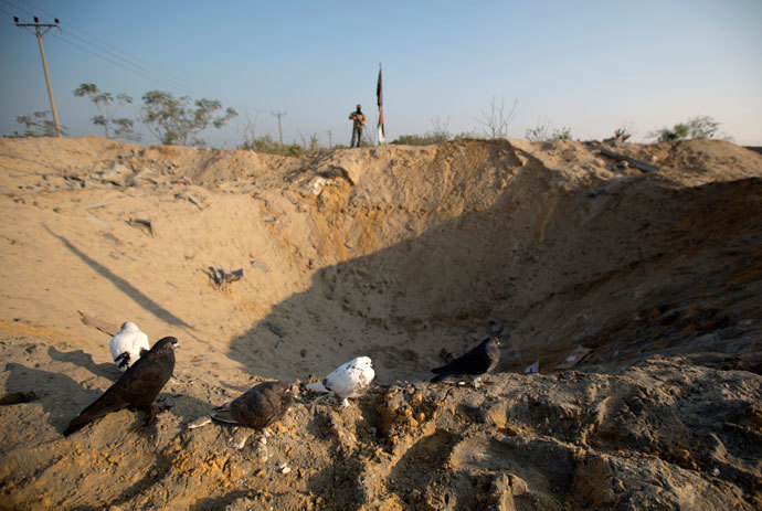 A crater is seen on the ground following an overnight Israeli air strike in Beit Lahia in the northern Gaza Strip on November 20, 2013.(AFP Photo / Mohammed Abed)