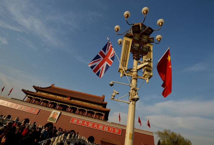 A British and a Chinise flag are displayed near the portrait of late Chinese leader Mao Zedong at Tiananmen Square in Beijing December 2, 2013.(AFP Photo / /Mark Ralston)