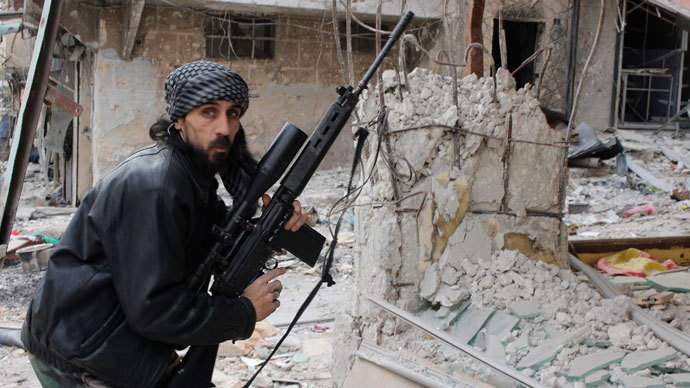 A rebel fighter from the Free Syrian Army holds a position with a Belgium made FAL rifle at a front line in the Salah al-Din neighbourhood of the northern Syrian city of Aleppo, on December 1, 2013.(AFP Photo / Mohammed Al-Khatieb)