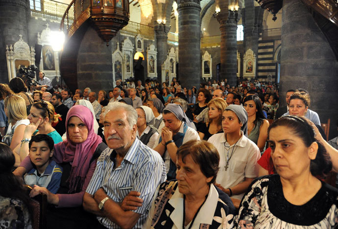  Syrian Christians attend a prayer vigil for peace at the Lady of Dormition, the Melkite Greek Catholic patriarchal cathedral in the Old City of Damascus, on September 7, 2013.(AFP Photo / STR)