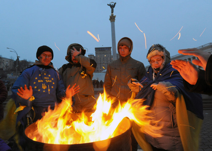 Pro-EU opposition demonstrators try to warm themselves near a bonfire during their stay on Independence Square in Kiev, early on December 6, 2013. (AFP Photo/Viktor Drachev) 