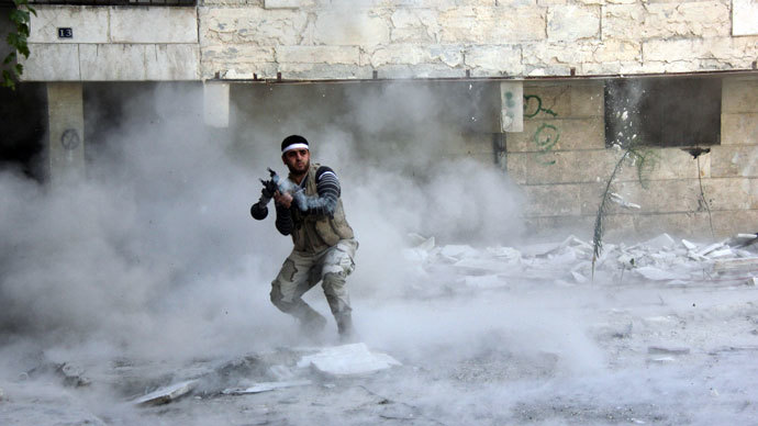 Opposition fighter firing an rocket propelled grenade (RPG) during clashes in the Salaheddin district of the northern Syrian city of Aleppo.(AFP Photo / Medo Halab)