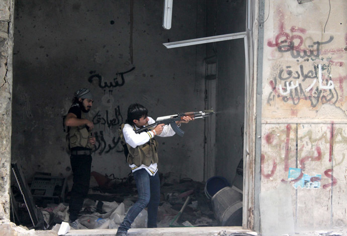 A rebel fighter from the Free Syrian Army fires his weapon during fighting against government forces on November 18, 2013 in the Salah al-Din neighbourhood of the northern Syrian city of Aleppo. (AFP Photo/Mahmud Al-Halabi)