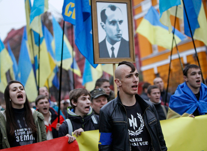 Activists of the Svoboda (Freedom) Ukrainian nationalist party shout slogans as they take part in a rally marking the 71st anniversary of the Ukrainian Insurgent Army (UPA), which fought both Nazi and Soviet forces in World War Two, and the feast of the Protecting Veil of the Mother of God in central Kiev, October 14, 2013. (REUTERS/ Gleb Garanich)