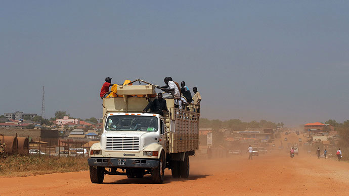 South Sudanese sit on a truck with their belongings as it heads out of Juba on December 21, 2013 where tension remains high fueling an exodus of both local and foreign residents from the south Sudanese capital.(AFP Photo / Tony Karumba)