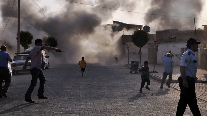 Smoke rises from the explosion area after several Syrian shells crashed inside Akcakale town in Turkey, killing at least five people on October 3, 2012, in Sanliurfa. Many.(AFP Photo / Rauf Maltas)
