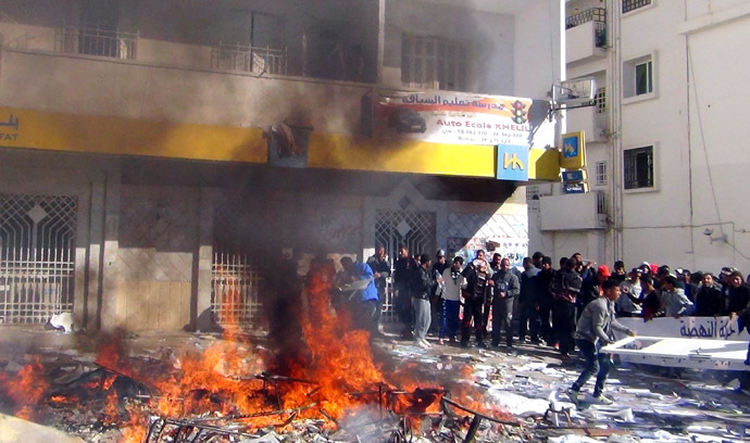Tunisians protestors set fire to documents and belongings of the country's ruling Islamist Ennahda party's outside their headquarters in the central Tunisian town of Gafsa on November 27, 2013, as a general strike was called to protest against poverty and lack of development. (AFP Photo)