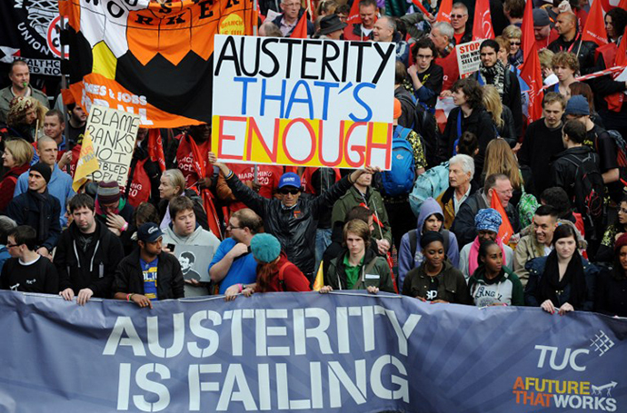 Demonstrators gather in central London on October 20, 2012, as they prepare to march against the government's austerity policies and call for an alternative economic strategy that puts jobs and growth first. (AFP Photo / Carl Court)