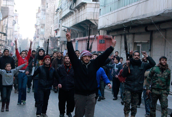 Civilians accompanied by Free Syrian Army fighters gesture as they march during a protest against fighters from the Islamic State in Iraq and the Levant (ISIL) in the Kadi Askar neighbourhood of Aleppo January 7, 2014. (Reuters / Abdalrhman Ismail)
