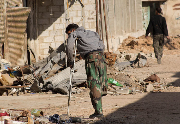 A Free Syrian Army fighter, with an amputated leg, walks with a crutch in Daraya, near Damascus January 15, 2014.(Reuters / Hussam Zeen)