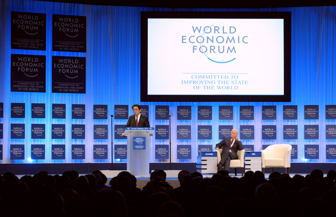 Japanese Prime Minister Shinzo Abe speaks as WEF Executive Chairman Klaus Schwab listens during the opening of the plenary session at the World Economic Forum in Davos on January 22, 2014. (AFP Photo / Eric Piermont) 