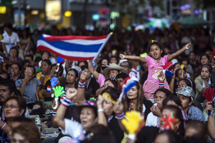 A girl reacts as she gathers with anti-government protesters while protest leader Suthep Thaugsuban (not pictured) speaks during a rally in central Bangkok, January 28, 2014. (Reuters/Nir Elias)