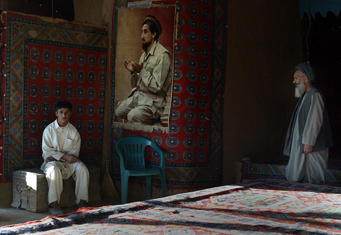The operators of a tea house with a big portrait of Afghan hero Ahmad Shah Masoud (Reuters / Caren Firouz)