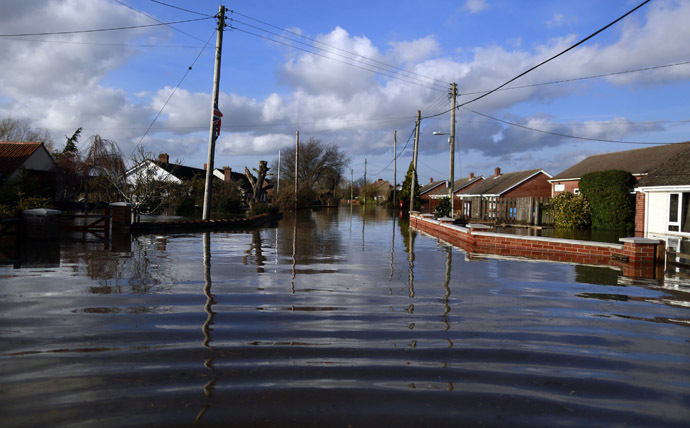 A flooded street is seen in urban landscape taken in the flooded Somerset village of Moorland February 16, 2014. (Reuters)