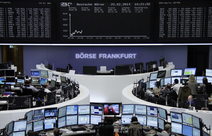 Traders are pictured at their desks in front of the DAX board at the Frankfurt stock exchange (Reuters)