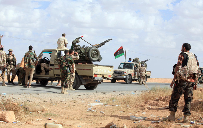 Pro-government fighters gather on October 23, 2012, one kilometer from the northern entrance to the town of Bani Walid, one of the final bastions of Moamer Kadhafi's ousted regime, as Libya celebrates the first anniversary of its "liberation" from the regime, even as fighting flared in a former bastion of the slain dictator. (AFP Photo)